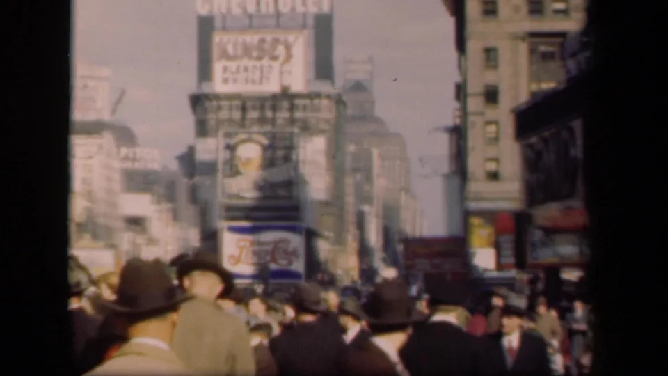 Final 1941 New York frame with a soft, grainy Times Square crowd scene beneath Chevrolet, Kinsey, and Pepsi-Cola signage.