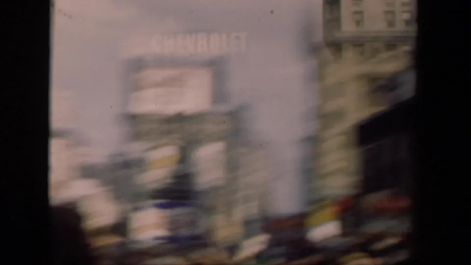 Motion-blurred 1941 New York street view with pedestrians and large commercial signs along tall building facades.