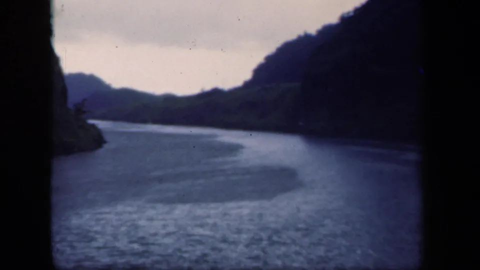 1941 New York 8mm still showing rippled river water, steep hillsides, and a cloudy sky from a handheld travel viewpoint.
