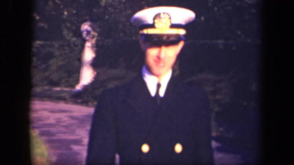 A closer 1941 home-movie view shows the Navy officer smiling slightly as he approaches the camera.