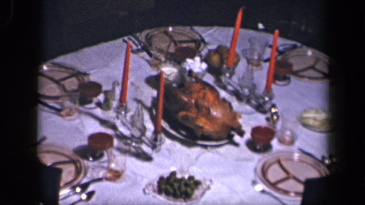 Sebring, Ohio 1942 8mm frame of a Thanksgiving table with turkey centerpiece, red candles, glass holders and place settings.