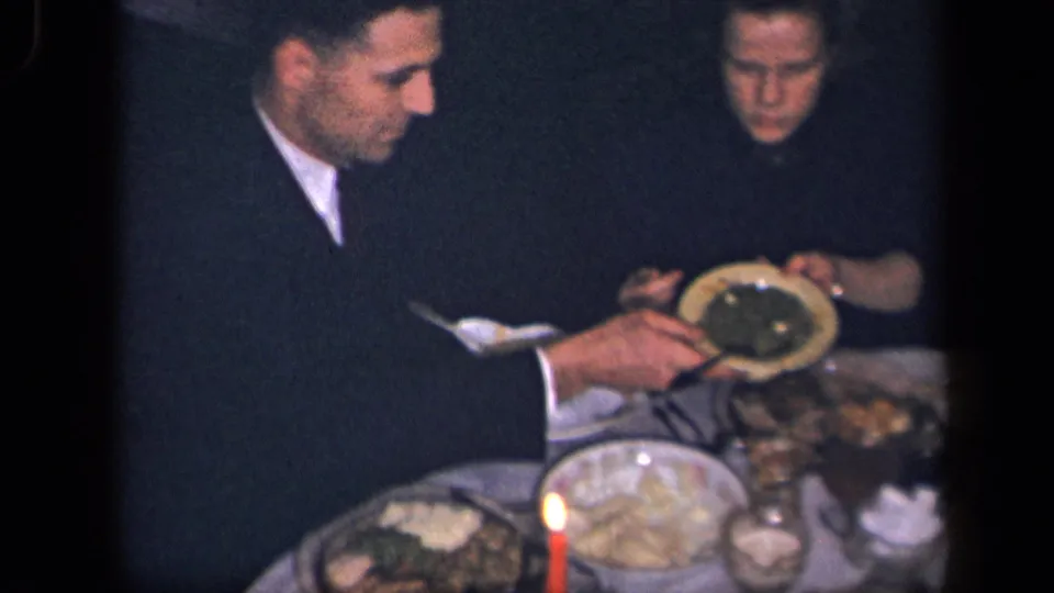 1942 Sebring, Ohio dinner scene with two visible diners, red candles, plates, serving dishes, and glassware.