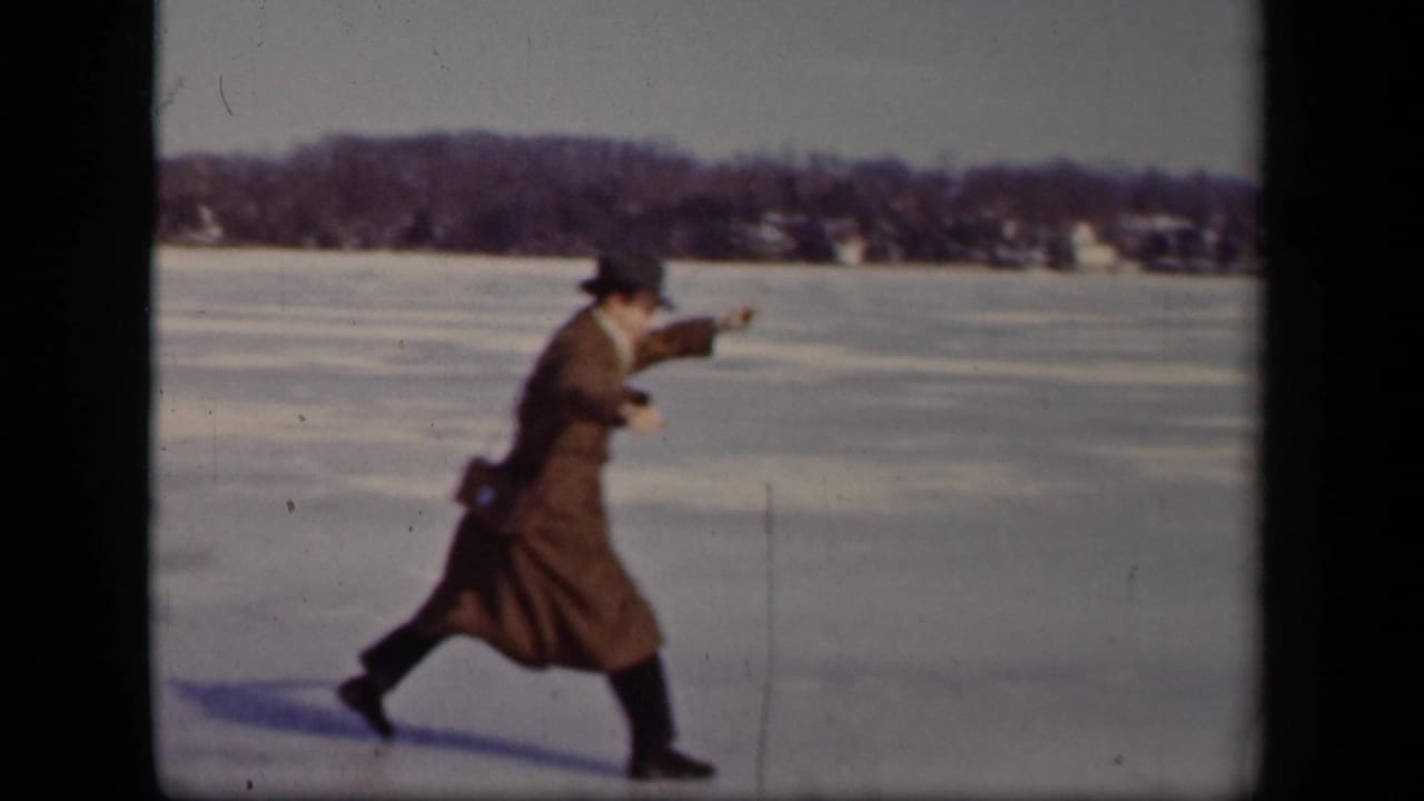 In Sebring, Ohio, 1942 home-movie footage, a man in a brown overcoat and brimmed hat moves cautiously across a frozen lake.