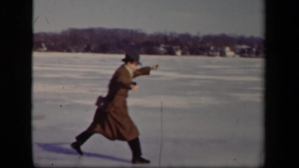 In Sebring, Ohio, 1942 home-movie footage, a man in a brown overcoat and brimmed hat moves cautiously across a frozen lake.