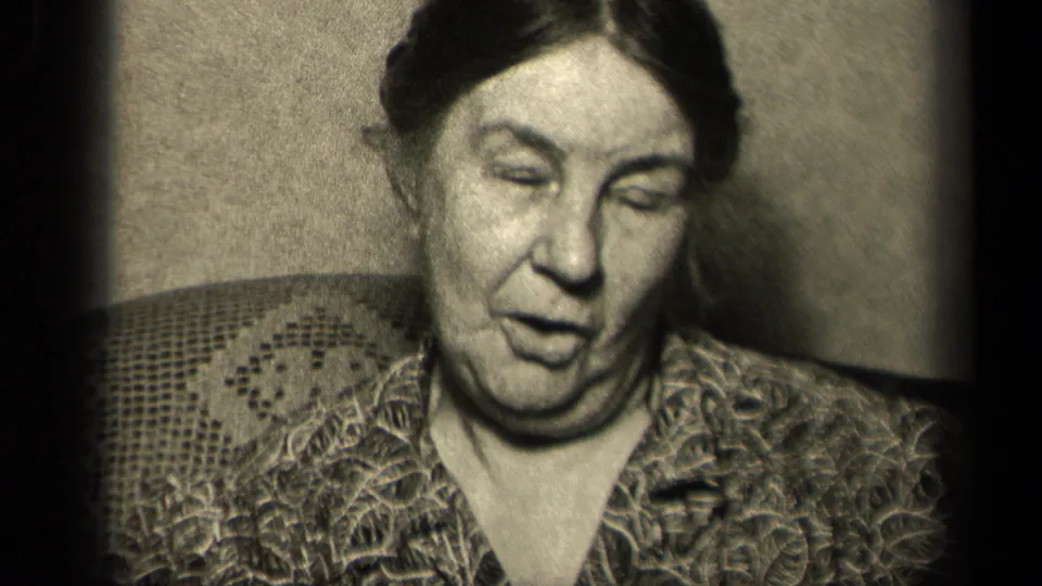 Older woman in a 1942 Sebring, Ohio home movie appears to speak while seated in close indoor framing.