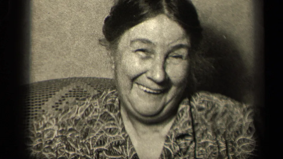 The 1942 Sebring, Ohio footage shows the woman laughing close to the camera, framed by dark 8mm edges and an upholstered chair.