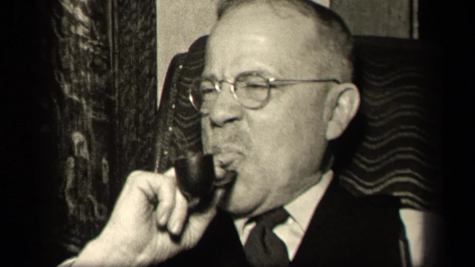 The 1942 Sebring, Ohio footage shows the suited man drawing on his pipe, with glasses, chair upholstery, and interior wall details visible.