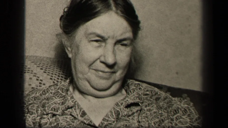 In the final 1942 Sebring, Ohio frame, the elderly woman faces forward again with a faint smile, framed tightly against the chair back and wall.