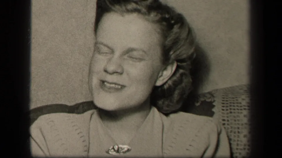 Younger woman appears mid-speech or laughter in a 1942 Sebring, Ohio domestic 8mm home-movie frame.
