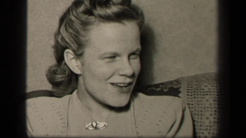 The woman turns toward someone off camera, smiling in a close black-and-white home-movie view from Sebring, Ohio in 1942.