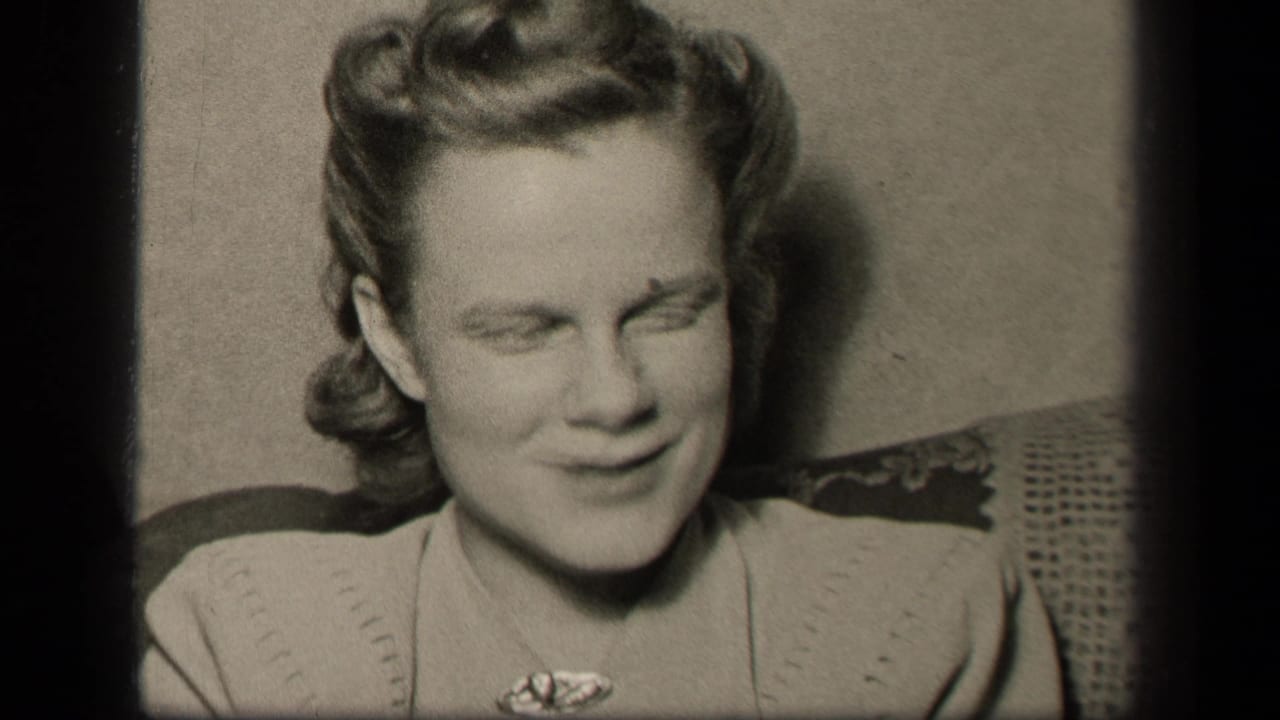 In supported 1942 Sebring, Ohio footage, a woman with styled curls smiles softly in a close interior shot.