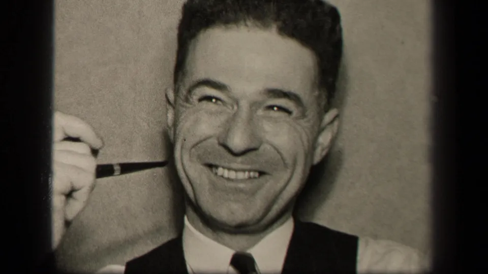 A close 1942 home-movie frame shows the Sebring, Ohio man grinning broadly with a pipe held just beside his mouth.