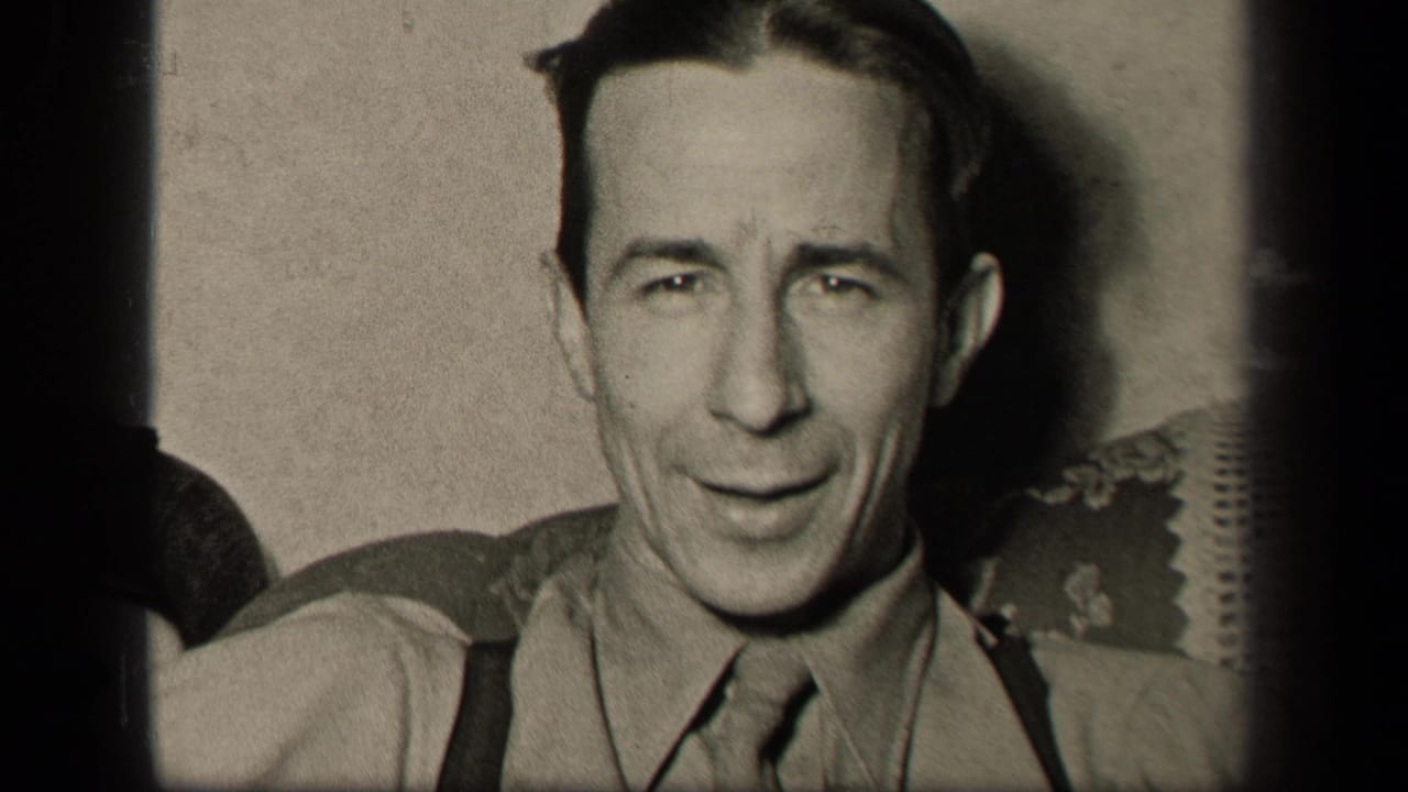 In a 1942 Sebring, Ohio home-movie frame, an adult man in a collared shirt, necktie, and suspenders sits on a sofa facing the camera.