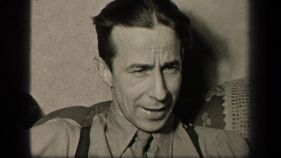 The man sits in a private interior in Sebring, Ohio, in 1942, looking downward with a thoughtful or furrowed expression.