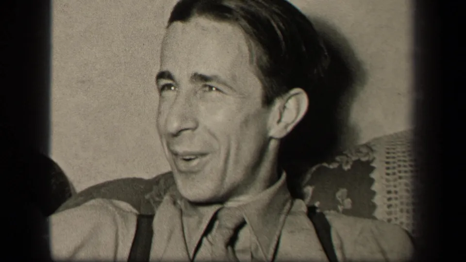 The 1942 Sebring, Ohio home-movie frame shows the seated man turned partly sideways, as if responding to someone off camera.