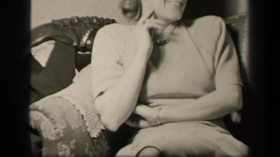 The upward pan reaches the woman's upper body as she leans on one hand in the Sebring, Ohio interior.