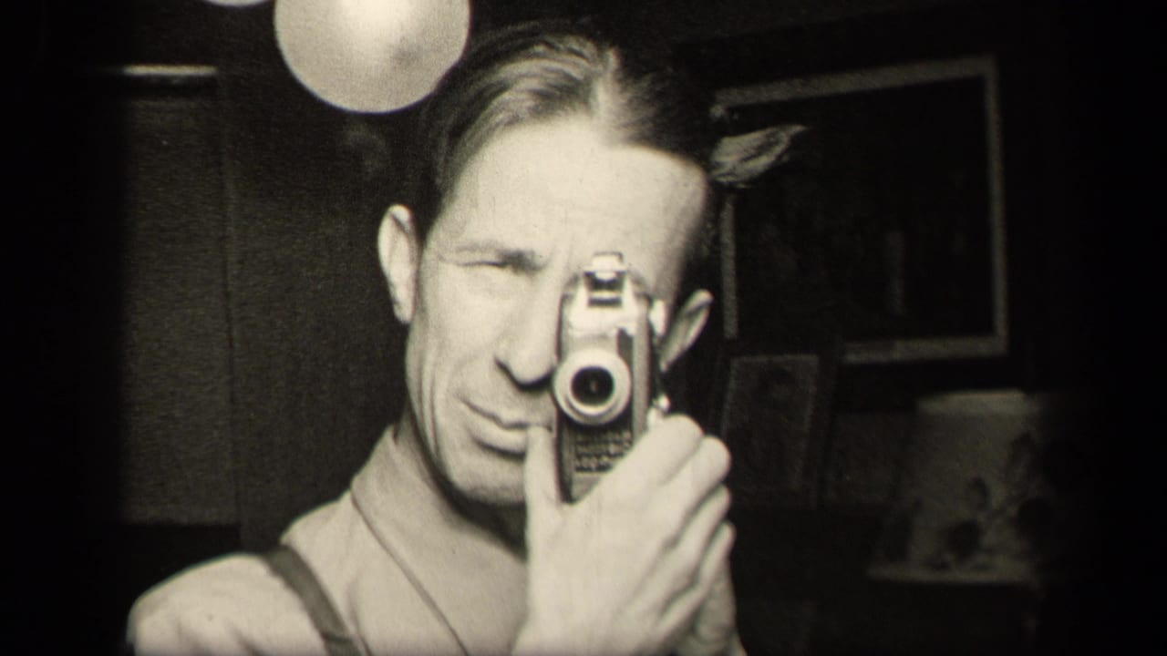 A 1942 Sebring, Ohio home-movie frame shows a man holding a small camera to his eye in a dim private room.