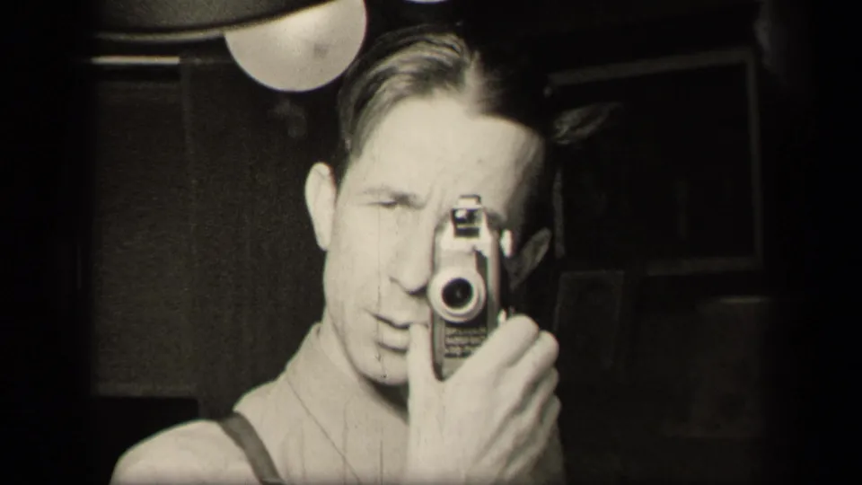 The cameraman remains close to the lens, with suspenders and a small movie camera visible in the 1942 home-movie frame.