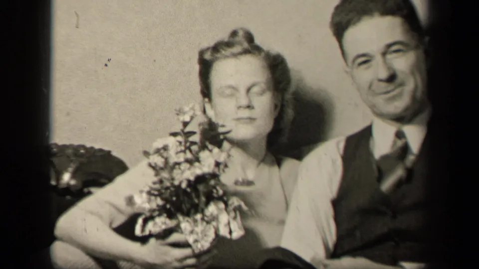 A posed couple appears indoors in the Sebring, Ohio 1942 footage, with the woman holding a bouquet and the man wearing a vest.