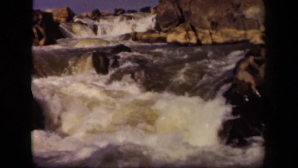 Vintage 8mm frame of rushing water and rugged rocks, identified by metadata as Baltimore, Maryland in 1943.