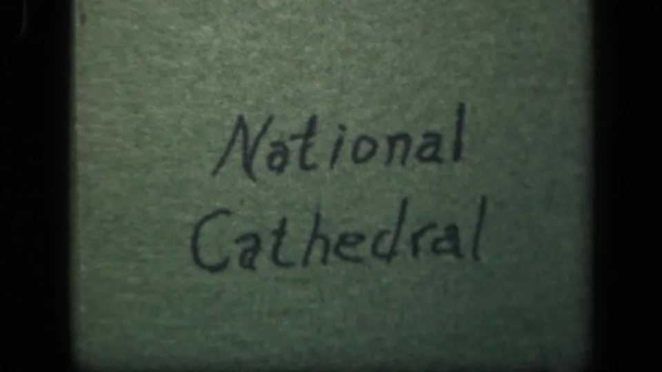 Second view of the handwritten National Cathedral title card, softly focused and framed by 8mm gate edges.