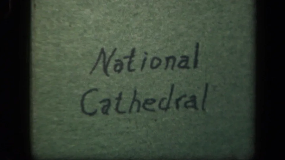 Final title-card frame showing National Cathedral written on green paper in vintage 8mm color footage.