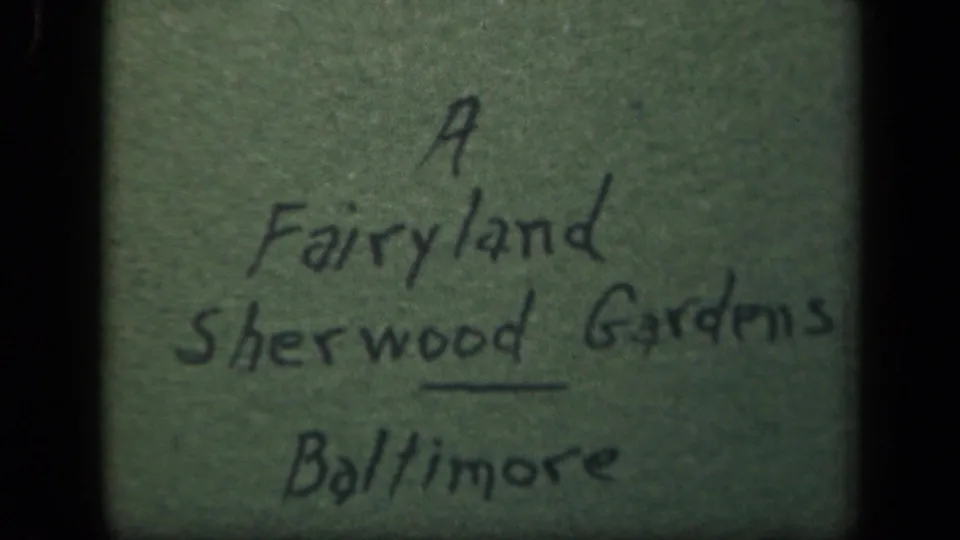 Second view of the handwritten Sherwood Gardens Baltimore title card, framed by dark 8mm film edges.