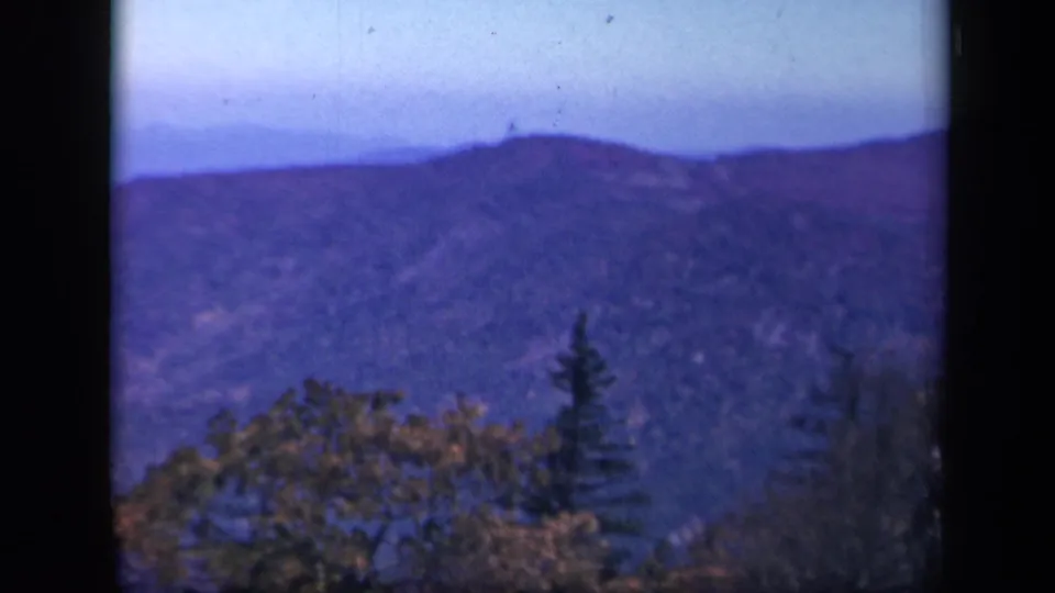 Vintage 8mm view from Skyline Drive showing a distant ridge line and winter tree cover in Virginia.