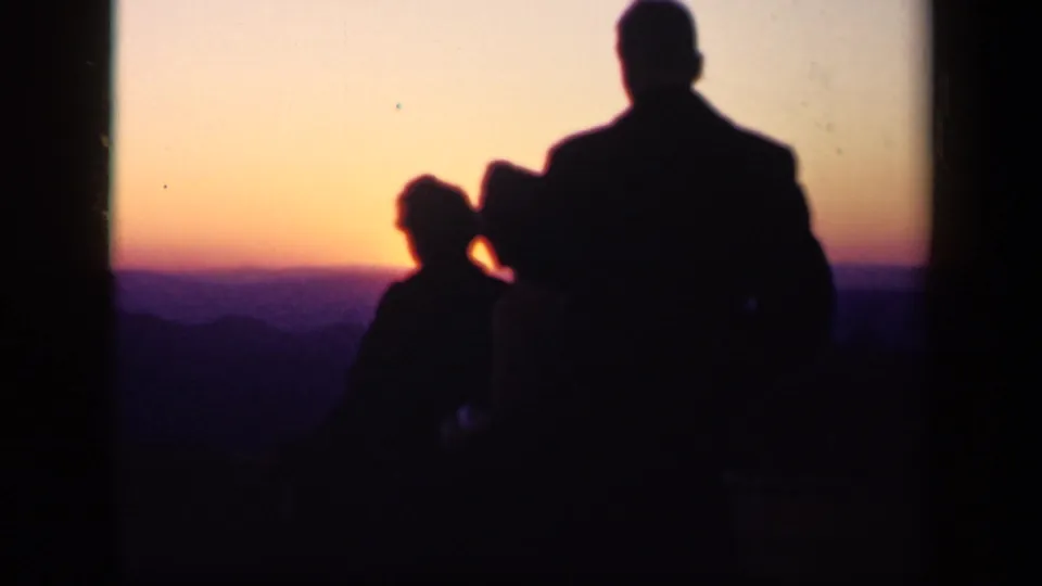 The couple is silhouetted close together before a darkening mountain horizon at Skyline Drive, Virginia, in 1943.