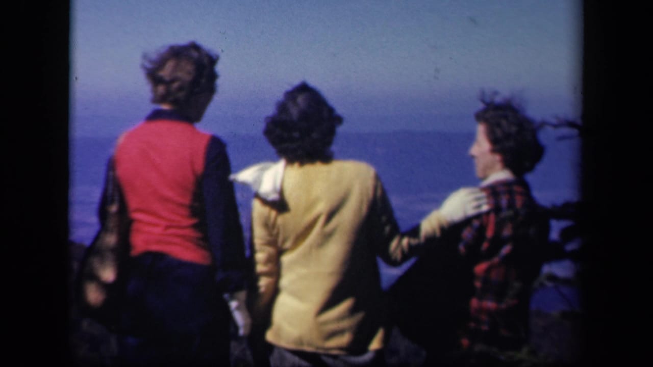 At the Virginia overlook, three women look outward as one in plaid turns slightly toward the others.
