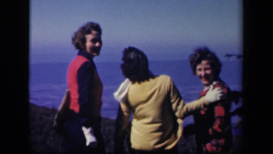 At the Virginia overlook, two of the women turn back toward the camera and smile as the wind blows their hair.