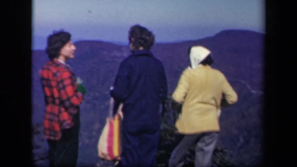 At the Virginia mountain overlook, one woman turns in profile while the others look toward the landscape.