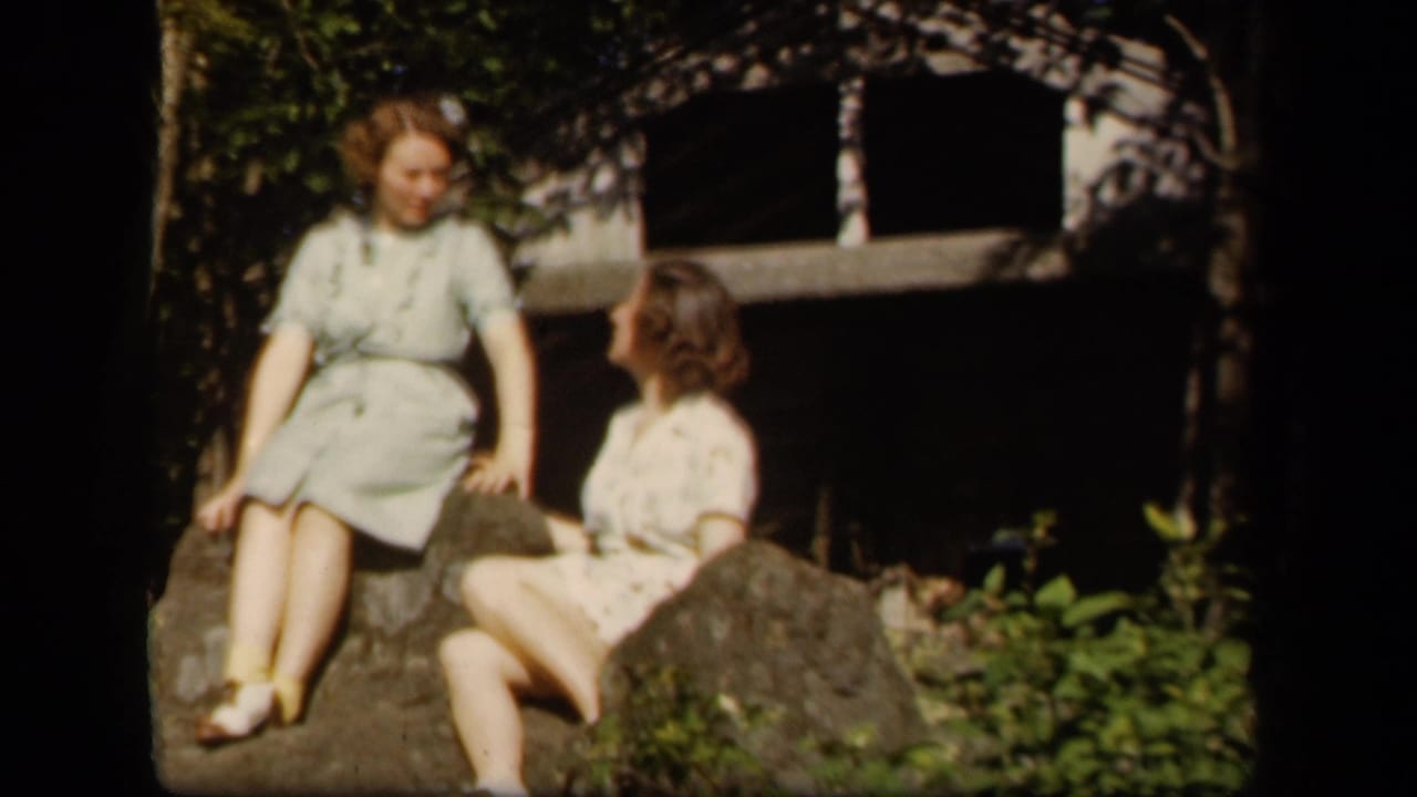 Two adult women in 1940s-style dresses relax on rocks outdoors at the supplied Skyline Drive, Virginia location.