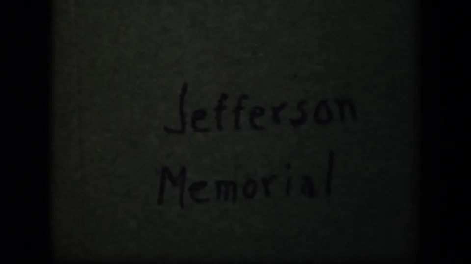 Handwritten Jefferson Memorial label appears on a dark green reel or card surface in the 8mm home movie.