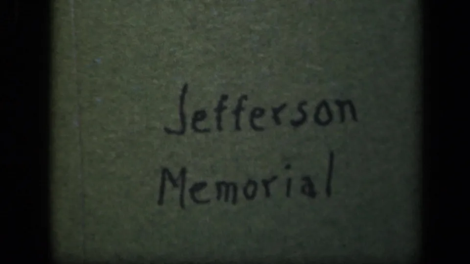 Final 1943 8mm frame holds on the handwritten Jefferson Memorial label, with dark gate edge and muted color.