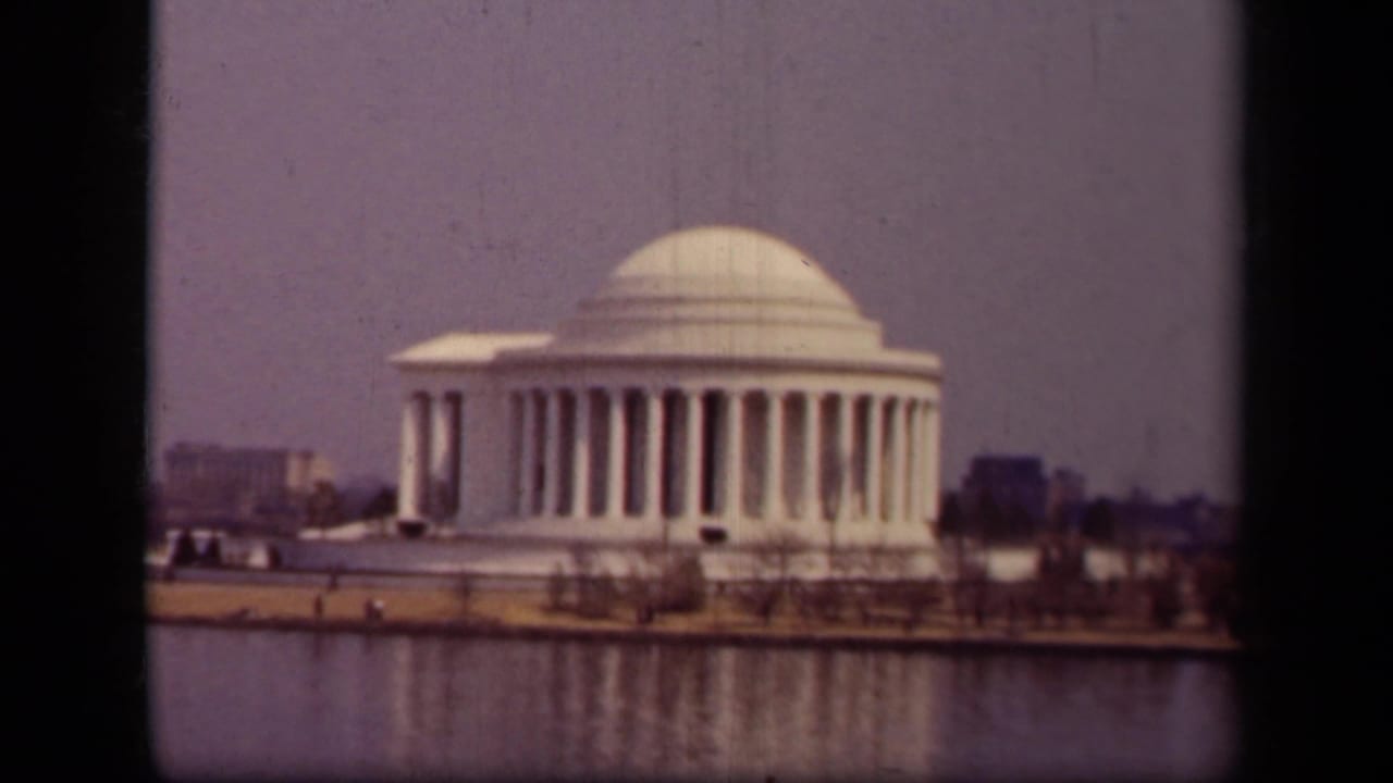 1943 8mm view of the Jefferson Memorial in Washington, DC from across the Tidal Basin under hazy light.