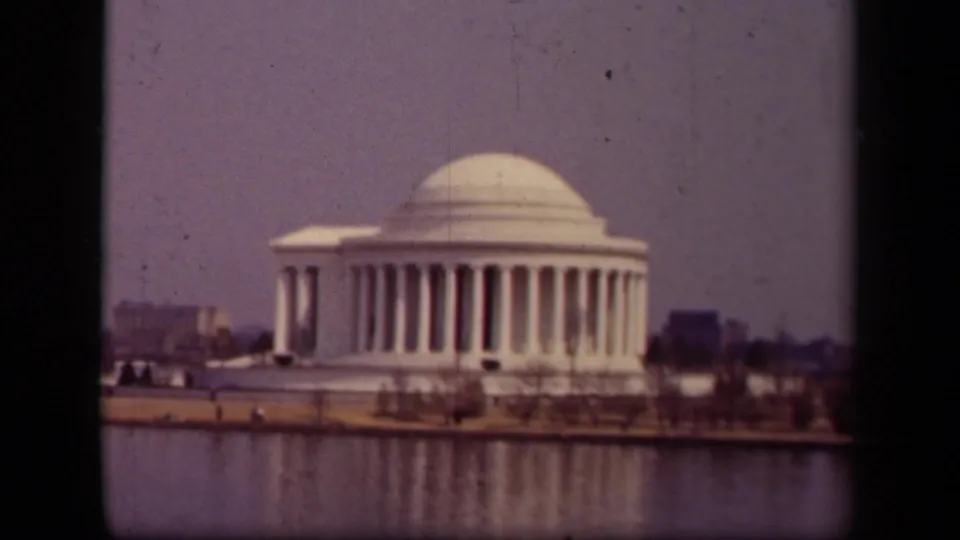 Hazy 1943 home-movie frame showing the Jefferson Memorial across the Tidal Basin in Washington, DC.