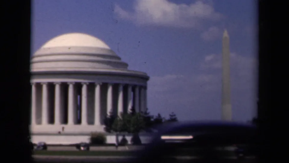 1943 Washington, D.C. home-movie frame showing the Jefferson Memorial at left and the Washington Monument beyond it.