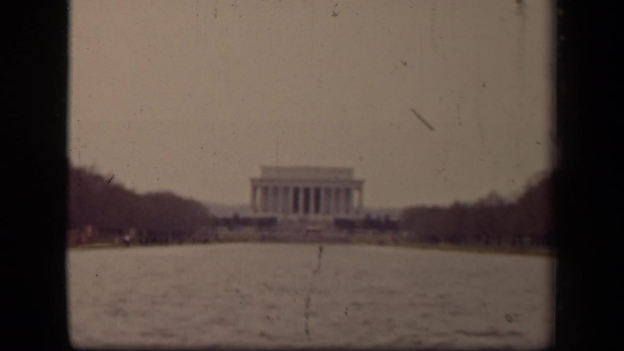 Distant Lincoln Memorial seen across the Reflecting Pool with dark film borders.