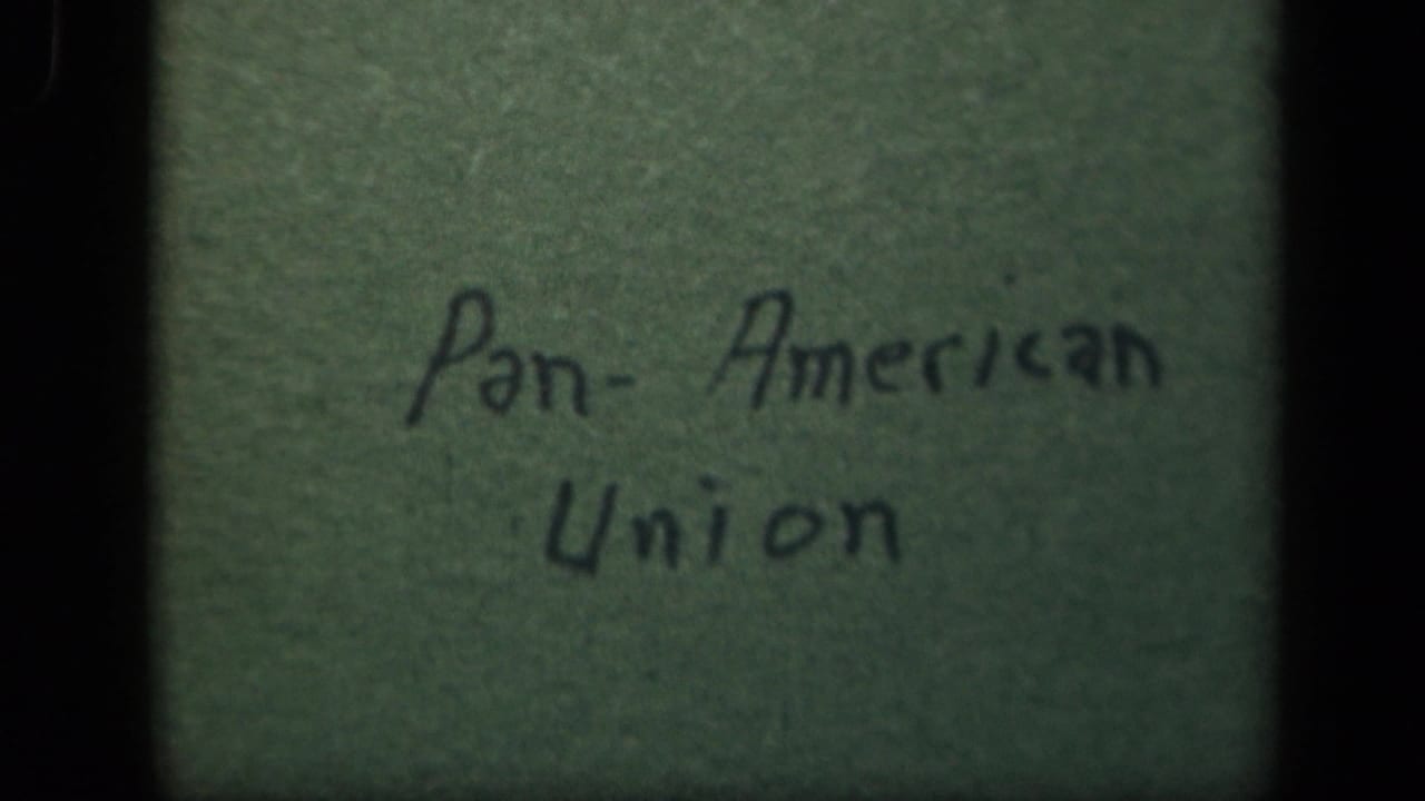 Handwritten Pan-American Union title card on green material, brighter on the right side.