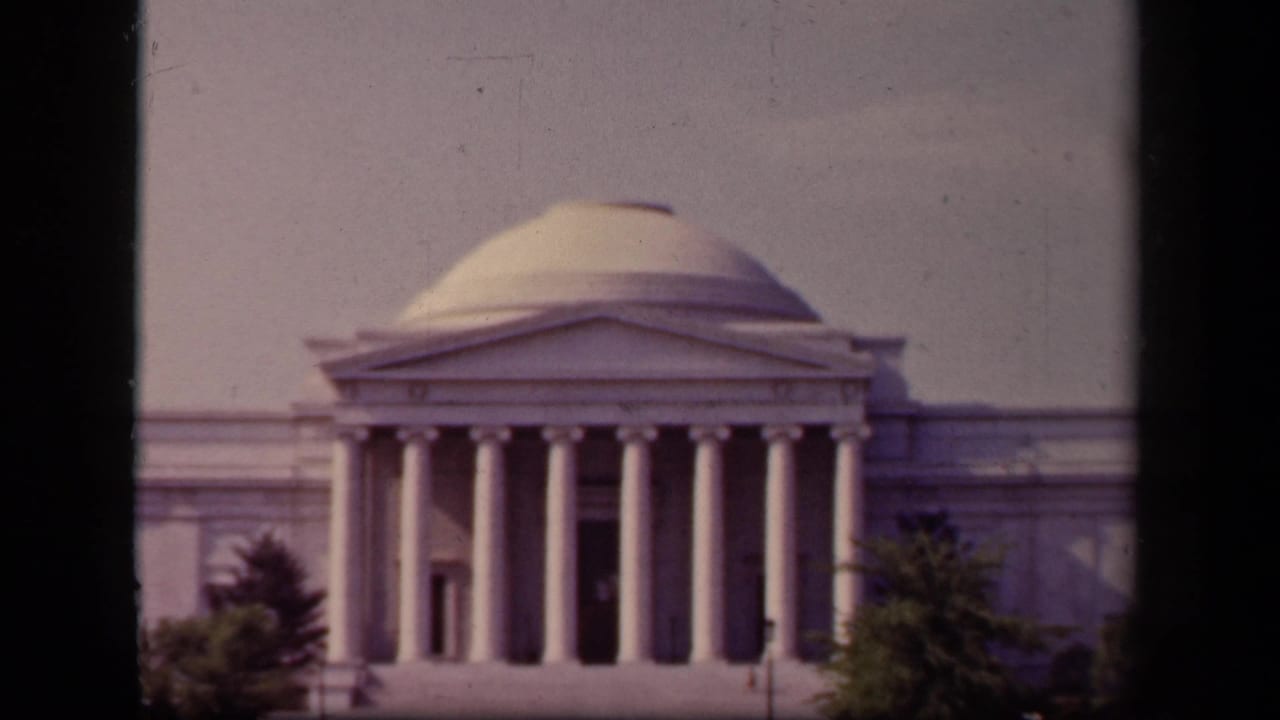 Closer framed view of the Jefferson Memorial with dome, columns, and trees.