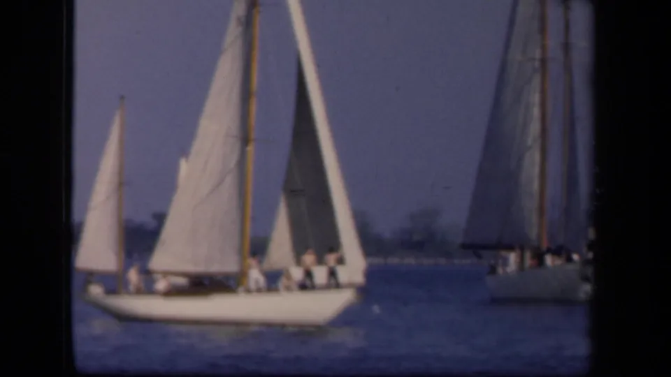A 1940s Washington, DC sailing scene shows a white sailboat carrying several people, with another sailboat at the right edge.