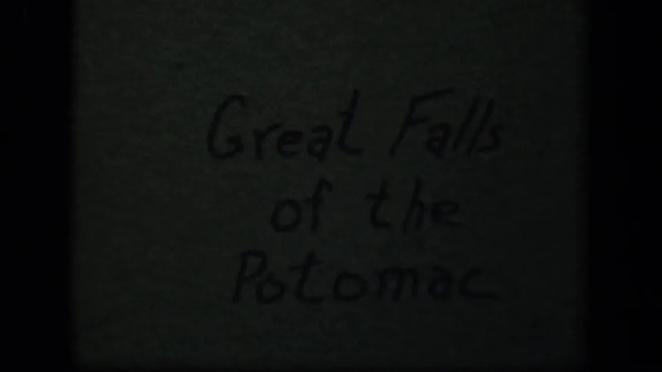 Handwritten 8mm title card reading Great Falls of the Potomac, dimly exposed within black film borders.