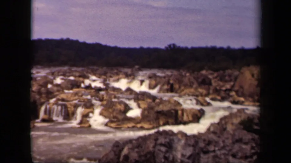 1943 8mm home-movie frame of white water cascading through rocks in a Washington, DC-area natural river setting.