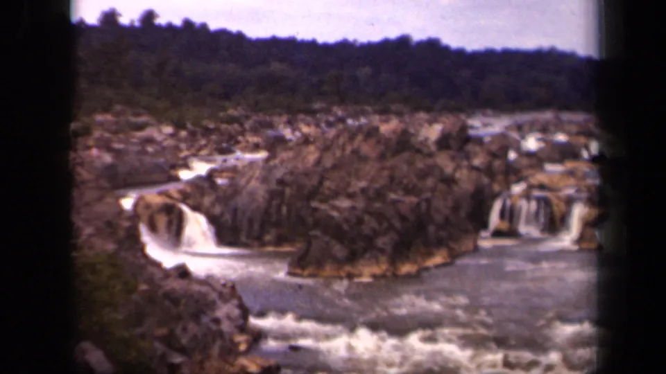 1943 8mm home-movie view near Washington, District of Columbia, showing cascades over brown rock into a broad river.