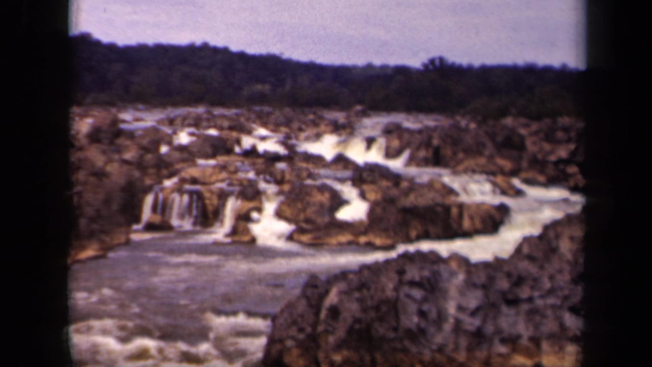Mid-pan 8mm view of rocky cascades and foaming water in Washington, DC, based on supplied clip metadata.