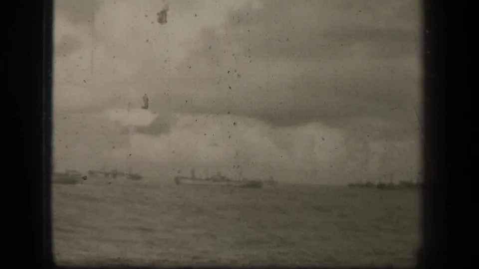 Leyte Gulf convoy view showing distant ships across open water, with heavy cloud cover and visible 8mm gate edge.