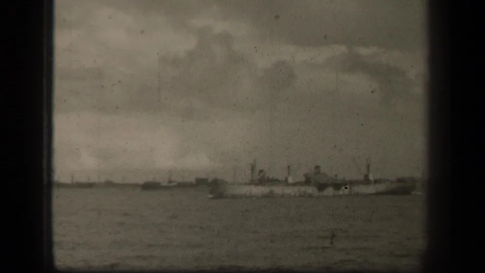 Several wartime naval vessels are visible from a distance on Leyte Gulf, with masts and funnels softened by 8mm grain.