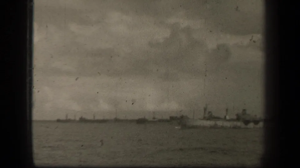 1944 Leyte Gulf footage shows distant ship silhouettes across open water under heavy clouds, with visible 8mm frame edges.