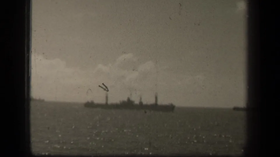 A vessel appears on the horizon in reported 1944 Leyte Gulf footage, with water glare and visible film wear.